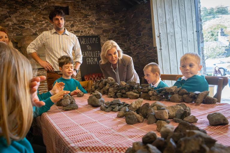 HRH The Duchess of Edinburgh joins in a fun activity with some children at Seatoller Farm. 
